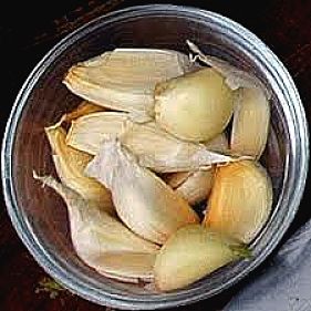 Peeled garlic ready for slicing or crushing